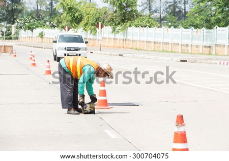 KHONKAEN, THAILAND - JULY 28: Workers repairing the damaged road that Damaged due to long used. July 28, 2015 in Khonkaen, Thailand