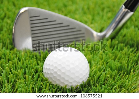 golf ball and club head with focus on the ball