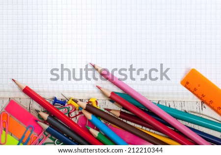 checked note paper with a pencil and paper clips