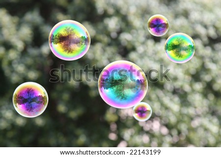 Whimsical, iridescent, rainbow bubbles floating