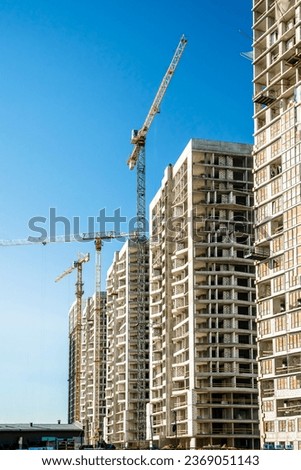 Similar – Image, Stock Photo Skyscraper building construction. Crane working in construction site. Property and real estate development industry. Apartment building construction. Background for REIT fund. Building for rent.