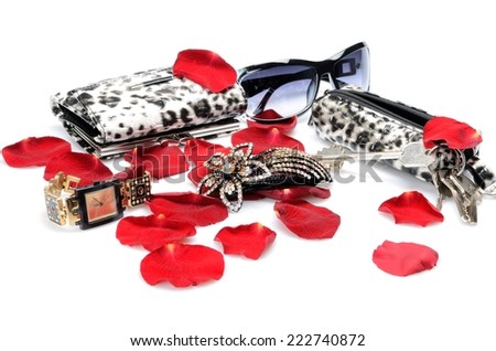 A Red rose petals, women\'s accessory Handbag for keys, sunglasses, wallet, watch. in still life