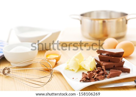 Ingredients for a mousse au chocolat including dark chocolate, eggs, butter, cream and sugar
