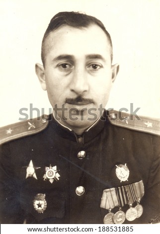 Ussr - CIRCA 1954: studio photo portrait of an artillery Major of the Soviet Army, awarded the Order of the Great Patriotic War, Order of Red Star,  SOVIET ORDER OF THE RED BANNER, and four medals.