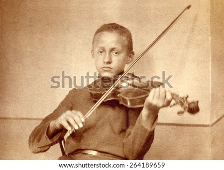 Russia - CIRCA 1971s: An antique Black & White photo of boy playing violin.