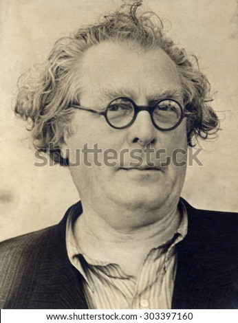Russia, - CIRCA 1940s:An antique studio portrait of middle-aged man in a suit, and glasses