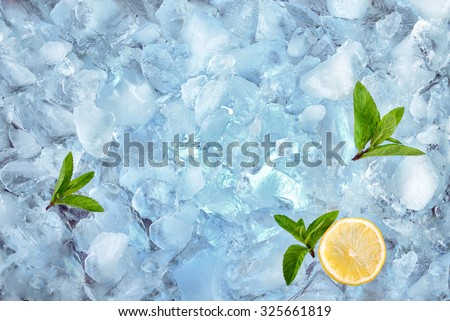 background with crushed ice cubes mint and lemon, top view