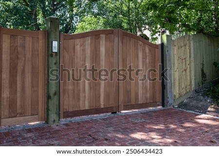 Similar – Image, Stock Photo large wooden gate with plain door handle, slanted wooden boards and painted with different green paint, which is peeling off