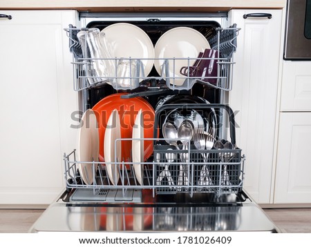 dishwasher close-up with washed dishes, easy to use and save water, eco-friendly, built-in kitchen dish washing machine