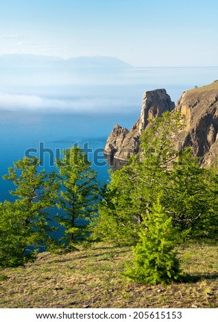 Summer fog over Lake Baikal. Northern Cape of Olkhon island