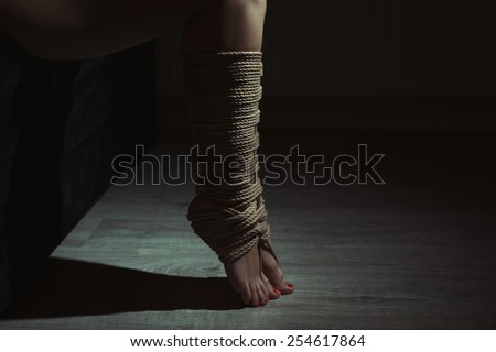 Beautiful legs tied with rope in bondage. Photo toning.