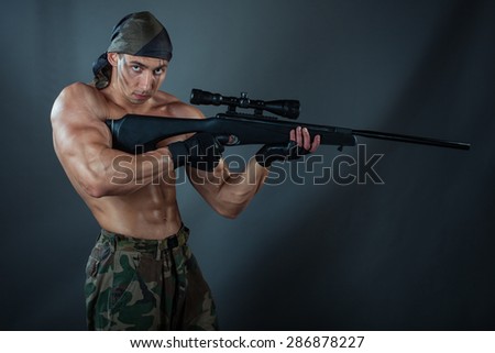 A man holding a rifle. Rifle with a telescopic sight. He was a sniper.