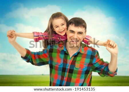 Joyful father with daughter on shoulders carefree and happy. Fathers day, family holiday, vacation