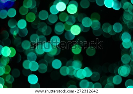 A green string of lights with a bokeh effect