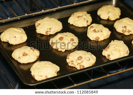 Baking delicious homemade chocolate chip cookies in a non stick pan and oven.