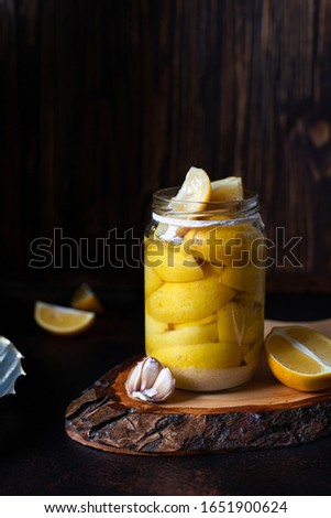Image, Stock Photo Fermented lemons in jars of salt, chili pepper and rosemary. Probiotics Fermented food. Pickled lemons.