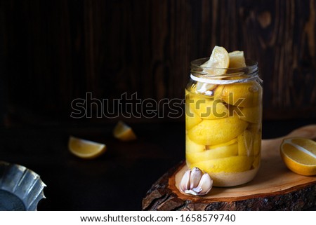 Similar – Image, Stock Photo Fermented lemons in jars of salt, chili pepper and rosemary. Probiotics Fermented food. Pickled lemons.