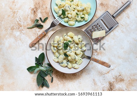 Similar – Image, Stock Photo Homemade gnocchi preparation on rustic kitchen table with ingredients. Top view. Potatoes dough . Italian food concept.