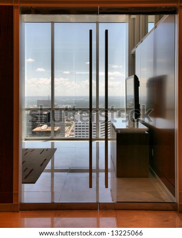 Office Interior with Flatscreen TV overlooking skyline in Houston, Texas\
(Release Information: Editorial Use Only. Use of this image in advertising or for promotional purposes is prohibited.)