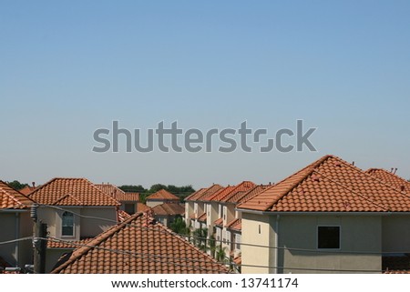 Springtime: Houses with Orange Spanish Roofs against Rich Blue Sky