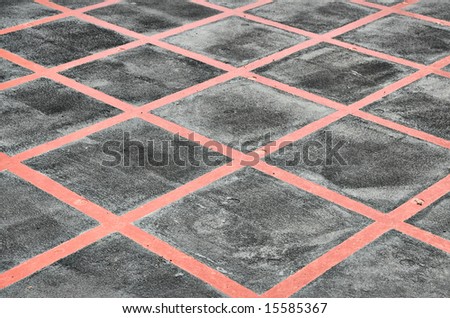 Red Criss Cross lines painted over grey concrete
