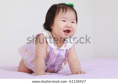 Cute Pretty Eleven Month Old Asian Infant Baby Girl in Purple and White Dress Leaning Crawling Forward and Smiling