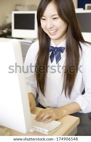 Female Japanese student typing on computer