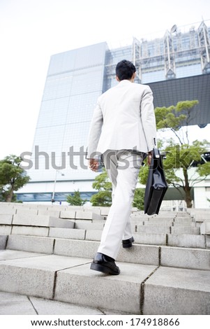 Back of Japanese business man walking