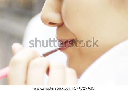 Woman painting a lipstick