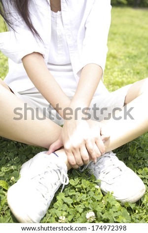 Woman who write something being cross-legged in the park