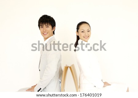 Japanese men and Japanese woman sitting back to back