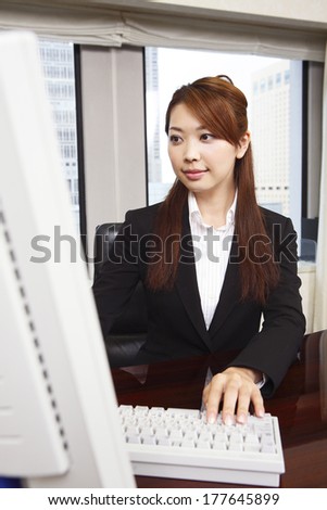 Japanese Office Lady working on a computer
