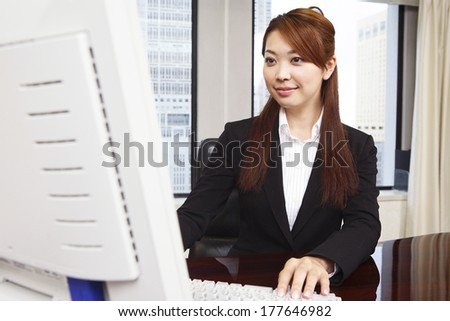 Japanese Office Lady working on al computer