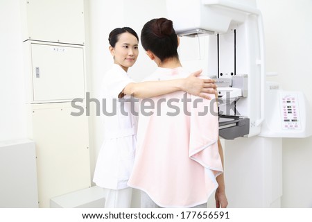 Japanese Engineer and patients undergo a test for breast cancer