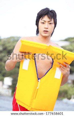 Japanese man who try to wear a life jacket