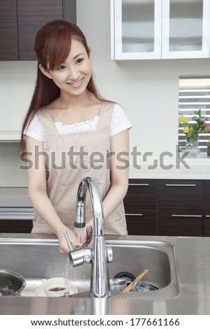 Japanese woman washing the dishes