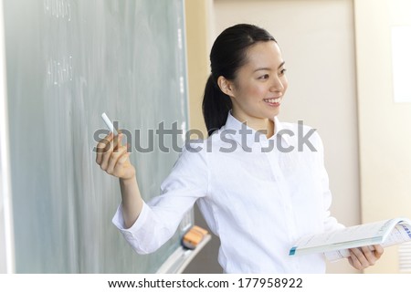 Female teachers to write a problem on the blackboard