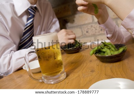 Businessmen enjoying a meal in the pub at the table