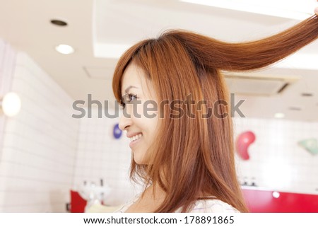 Japanese woman having hair cut in salon
