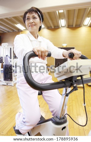 Japanese elderly woman on an exercise bike