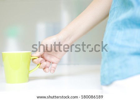 Hand of a Japanese woman with a mug