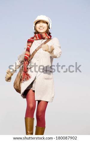 Japanese woman jumping while listening to music
