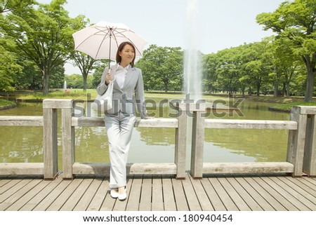 Japanese office lady standing by office ladies in the park
