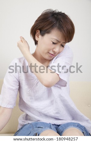 Japanese woman suffering from stiff neck,