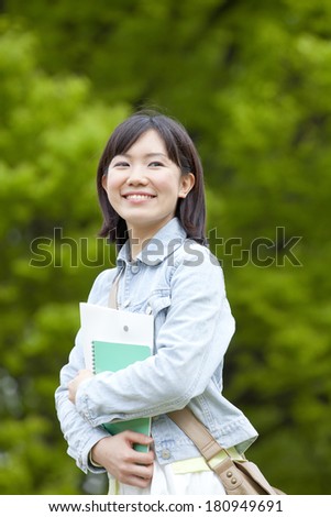 Japanese student looking back and smiling,