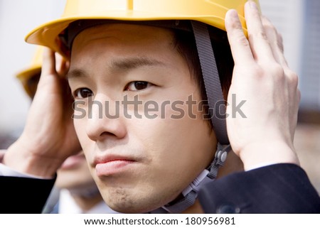 Japanese businessman wearing a helmet