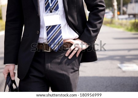 Businessmen holding his waist with his hands