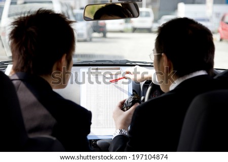 Business Man Reviewing The Documents In The Car