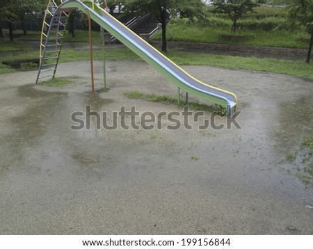 Wet Slide In The Rainy Park