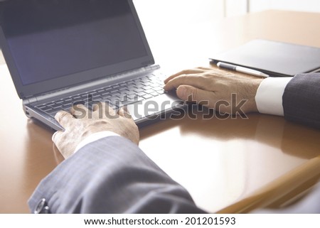 a hand of businessman typing keyboard on a laptop